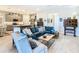 Open floor plan with a teal couch, kitchen view, and wooden coffee table at 445 Via Abruzzi St, Poinciana, FL 34759