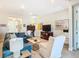 Living area showcasing a sectional sofa, a large TV, and a view into the foyer at 445 Via Abruzzi St, Poinciana, FL 34759