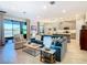 Open living space with a teal couch, kitchen island view, and sliding door access to the outdoors at 445 Via Abruzzi St, Poinciana, FL 34759
