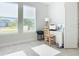 Home office featuring a wooden desk and chair, and two large windows at 445 Via Abruzzi St, Poinciana, FL 34759