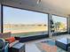 Spacious screened porch with lake view and comfortable seating at 445 Via Abruzzi St, Poinciana, FL 34759