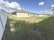 Large grassy backyard with a white vinyl fence at 502 Pentas Ln, Haines City, FL 33844