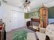 Adorable bedroom featuring a crib, teepee, and leafy decor at 502 Pentas Ln, Haines City, FL 33844