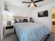 Bedroom with a queen-sized bed, a ceiling fan, and a flat screen TV at 502 Pentas Ln, Haines City, FL 33844