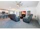 Open concept living room and kitchen, with gray sofas and a large TV at 502 Pentas Ln, Haines City, FL 33844