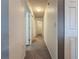 A long hallway with carpeted floors and doors leading to bedrooms at 502 Pentas Ln, Haines City, FL 33844