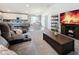 Open concept living room and kitchen, with gray sofas and a large TV at 502 Pentas Ln, Haines City, FL 33844