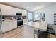 Modern kitchen with white cabinets, stainless steel appliances, and marble countertops at 502 Pentas Ln, Haines City, FL 33844