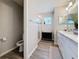 Bathroom with a toilet, shower, and double vanity at 502 Pentas Ln, Haines City, FL 33844