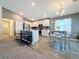 Modern kitchen with island, stainless steel appliances, and light wood floors at 502 Pentas Ln, Haines City, FL 33844