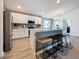 Modern kitchen with island, stainless steel appliances, and light wood floors at 502 Pentas Ln, Haines City, FL 33844