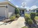 Front entry with walkway, landscaping, and a two-car garage at 502 Pentas Ln, Haines City, FL 33844