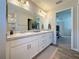 Double vanity bathroom with a marble countertop and a large mirror at 502 Pentas Ln, Haines City, FL 33844