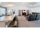 Open concept living room and kitchen, with gray sofas and a large TV at 502 Pentas Ln, Haines City, FL 33844