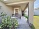 Covered porch with seating area, perfect for relaxing outdoors at 502 Pentas Ln, Haines City, FL 33844