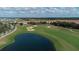 Aerial view showing homes, golf course, and pond at 712 Whistling Straits Blvd, Davenport, FL 33896