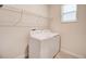 Bright laundry room with washer, dryer and overhead shelving at 712 Whistling Straits Blvd, Davenport, FL 33896