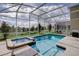 Screened pool and spa with a view of nature at 712 Whistling Straits Blvd, Davenport, FL 33896