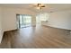 Spacious living room with sliding glass doors and wood-look floors at 111 Winsor Ave, Davenport, FL 33837