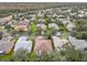 Aerial view of house and neighborhood with pond at 141 Marabella Loop, Poinciana, FL 34759