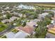 Aerial view of house and neighborhood with pond at 141 Marabella Loop, Poinciana, FL 34759