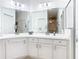 Bright bathroom boasts double sinks, ample storage, and a large mirror at 141 Marabella Loop, Poinciana, FL 34759