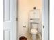 Small half bathroom with toilet and storage cabinet at 141 Marabella Loop, Poinciana, FL 34759