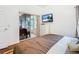 Bedroom with a king-size bed and sliding doors leading to a sunroom at 141 Marabella Loop, Poinciana, FL 34759