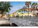 Waterfront community with charming buildings and a stone bridge at 141 Marabella Loop, Poinciana, FL 34759