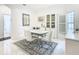 Bright dining room features a glass table with white chairs and an area rug at 141 Marabella Loop, Poinciana, FL 34759