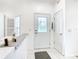 Bright entryway with white door, tiled floors, and built-in shelving at 141 Marabella Loop, Poinciana, FL 34759