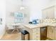Eat-in kitchen with white cabinets, stainless steel appliances, and a breakfast bar at 141 Marabella Loop, Poinciana, FL 34759