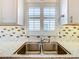 Double stainless steel sink with white countertops at 141 Marabella Loop, Poinciana, FL 34759