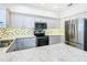 Modern kitchen with stainless steel appliances and light gray cabinets at 141 Marabella Loop, Poinciana, FL 34759