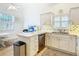 Kitchen features white cabinets, stainless steel appliances, and a breakfast nook at 141 Marabella Loop, Poinciana, FL 34759