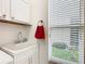 Laundry room with utility sink and window at 141 Marabella Loop, Poinciana, FL 34759