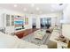 Living room with hardwood floors, built-in shelving, and access to a lanai at 141 Marabella Loop, Poinciana, FL 34759