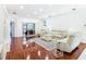 Spacious living room with hardwood floors, recessed lighting, and comfy seating at 141 Marabella Loop, Poinciana, FL 34759