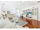 Living room boasts hardwood floors, comfy seating, and an entertainment center at 141 Marabella Loop, Poinciana, FL 34759