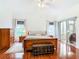 Main bedroom with hardwood floors and sliding glass doors at 141 Marabella Loop, Poinciana, FL 34759