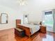 Spacious main bedroom with hardwood floors and a king-size bed at 141 Marabella Loop, Poinciana, FL 34759