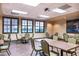 Bright meeting room with tables, chairs, and large windows at 141 Marabella Loop, Poinciana, FL 34759