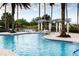 Relaxing resort-style pool with a waterfall feature and lush landscaping at 141 Marabella Loop, Poinciana, FL 34759