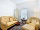 Relaxing sitting area furnished with armchairs and a sofa at 141 Marabella Loop, Poinciana, FL 34759