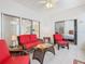 Bright sunroom boasts comfortable seating and view of backyard at 141 Marabella Loop, Poinciana, FL 34759
