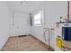 Laundry room with tile flooring, door, window and water heater at 2108 Lemon St, Haines City, FL 33844