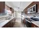 Modern kitchen with granite countertops and dark wood cabinets at 2108 Lemon St, Haines City, FL 33844