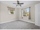 Spacious bedroom with two windows, ceiling fan, and carpet flooring at 2108 Lemon St, Haines City, FL 33844