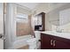 Bathroom with tub, shower, vanity, and linen cabinet at 2108 Lemon St, Haines City, FL 33844