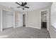 Spacious bedroom with ceiling fan, carpet, and a private bathroom at 2108 Lemon St, Haines City, FL 33844